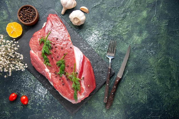 Overhead View of Fresh Red Raw Meat with Green Ingredients and Pepper on a Mixed Color Background – Free Stock Photo Download