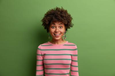 Pleased Smiling Woman with Afro Hair Indicating Cheerful Mood – Free Stock Photo, Download for Free