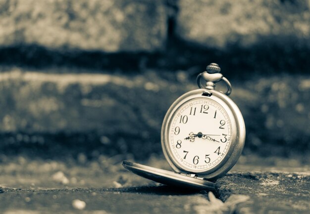 Close-up of Pocket Watch on Footpath – Free Stock Photo for Download