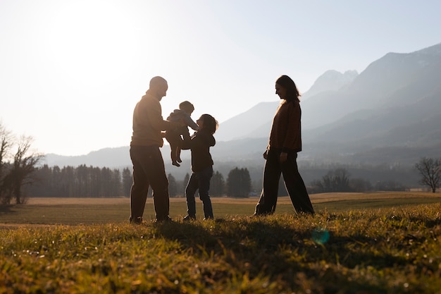 Family Silhouette in Nature at Sunset – Free Download