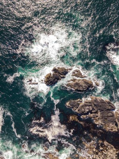 Aerial Vertical Shot of a Sea with Rocky Stones – Free Stock Photo for Download