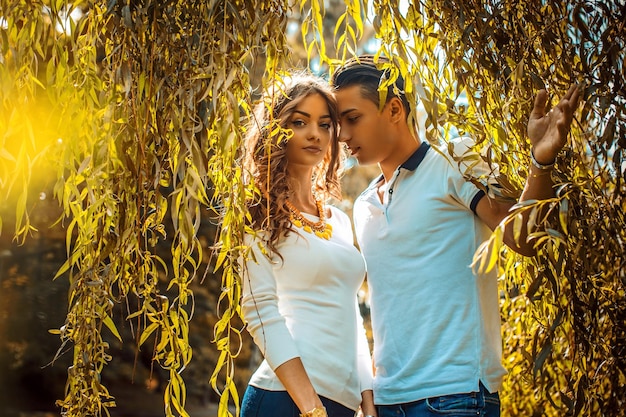 Young Casual Couple Enjoying Each Other Under a Green Tree – Free Stock Photo, Download Free