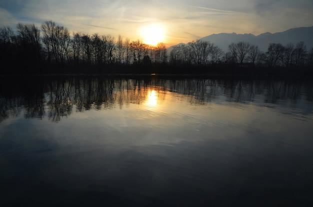 Evening Sunset over Alpine Lake Surrounded by Trees and Swiss Alps – Free to Download