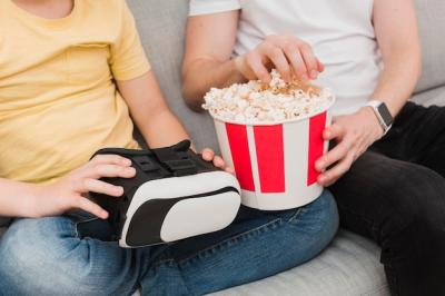 High Angle View of Man and Boy Enjoying Virtual Reality and Popcorn – Free Download