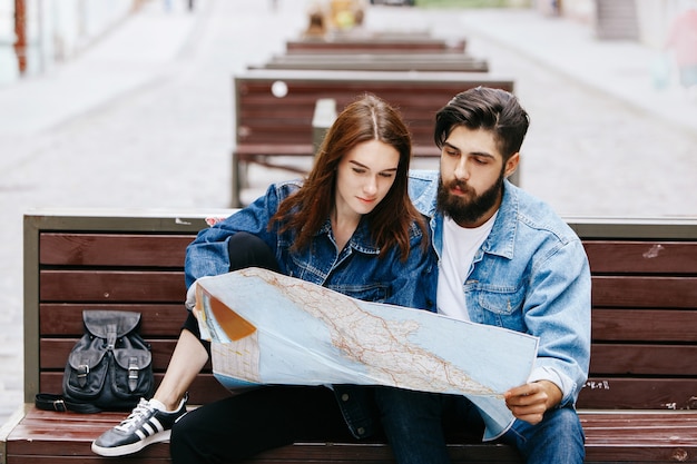 Exploring an Old City: Couple Examining a Map on a Bench – Free Stock Photo, Download Free