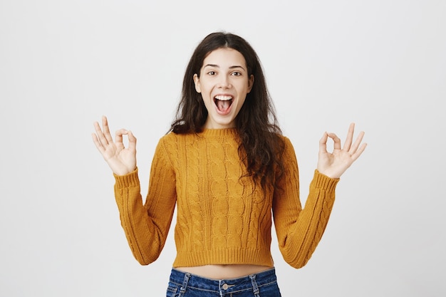 Pleased Girl Making Okay Gesture – Free Stock Photo for Download