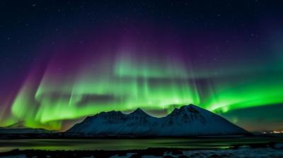 A Stunning Northern Lights Display Over a Mountain Range – Free Download