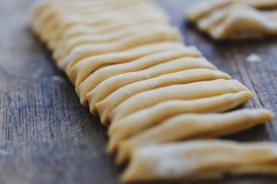 Fresh Homemade Pasta Surrounded by Flour on a Wooden Board – Free Download