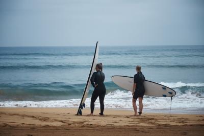 Two Women in Wetsuits with Surfboards Preparing for Summer Waves – Free Stock Photo for Download