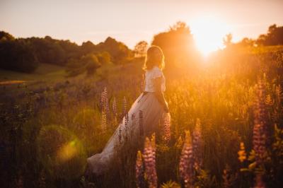 Stunning Woman in Bright Dress Walking Across Field at Sunset – Free Stock Photo, Download for Free