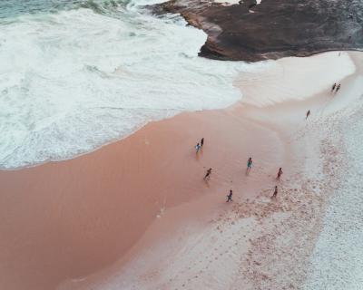People Enjoying a Sunny Day at a Sandy Beach with Beautiful Waves – Free Download