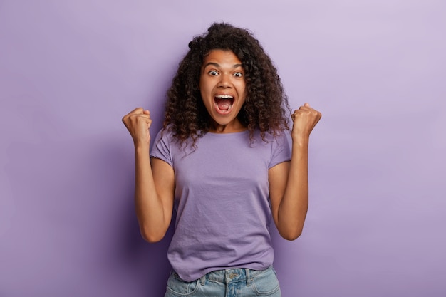 Dark Skinned Woman Celebrating Victory in Purple T-Shirt â Free Download