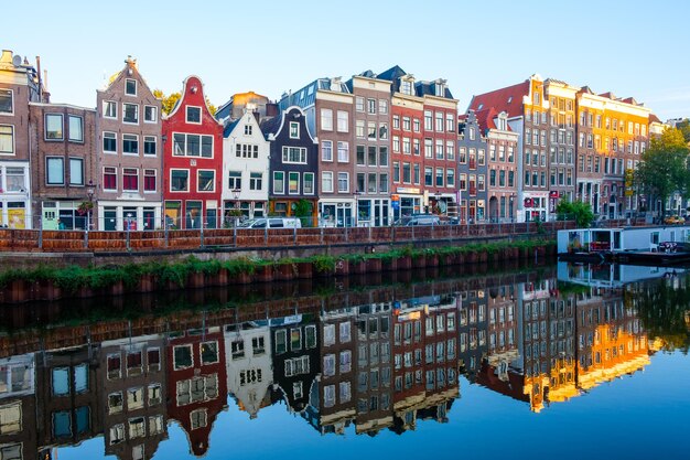 Colorful Buildings Reflected in a Canal in Amsterdam, Netherlands – Free Download