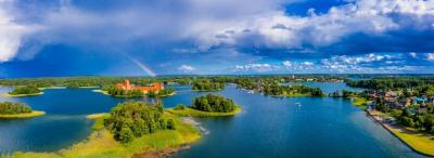 Aerial Shot of a Stunning Lake Surrounded by Lush Forests and an Island Castle – Free to Download