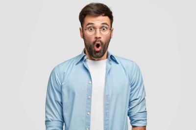 Terrified Unshaven Man in Blue Shirt with Disbelief and Surprise – Free Stock Photo for Download