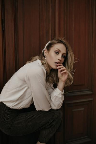 Calm Thoughtful Blonde Young Lady Squatting Near Wooden Door – Free Download