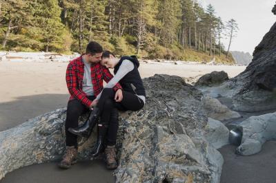 Couple Embracing on a Beach Rock – Free Download