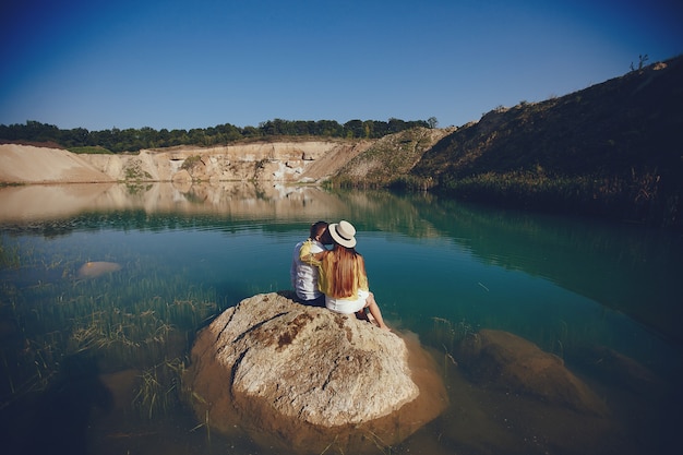 Couple by Tranquil Blue Water – Free Stock Photo for Download