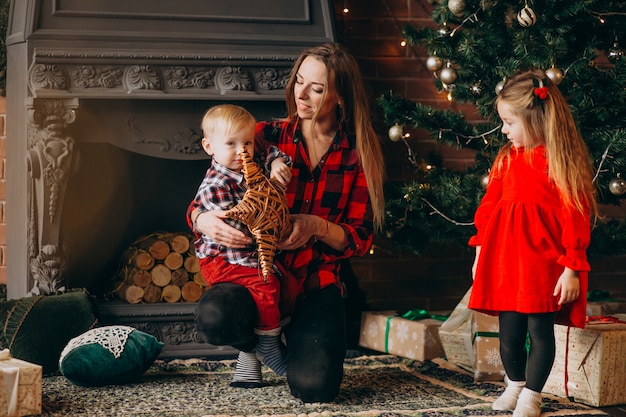 Mother and Children by Christmas Tree – Free Stock Photo for Download