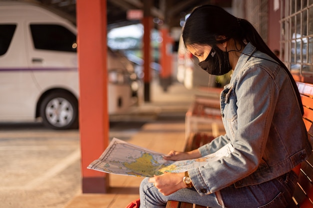 Traveler Girl Checking Directions on Map – Free Download