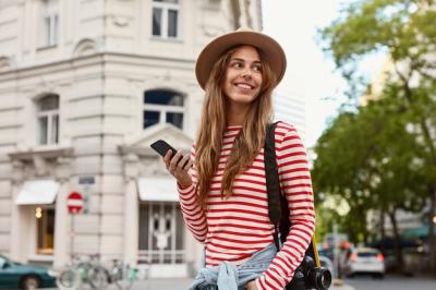 Happy Female Traveler Taking Photos and Texting with Smartphone | Free Stock Photo, Download Free