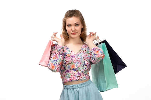 Young Attractive Lady in Colorful Floral Shirt and Blue Skirt Holding Shopping Packages – Free Stock Photo for Download