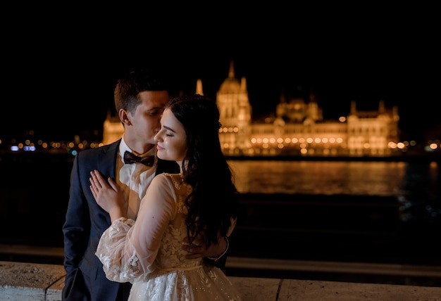 Groom and Bride Portrait with Stunning Night Town View in Architectural Europe – Free to Download