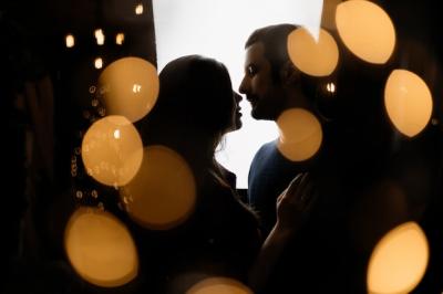 Silhouettes of Man and Woman Surrounded by Yellow Christmas Lights – Free Download