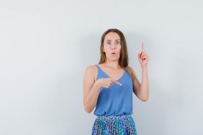 Young Lady in Blue Blouse and Skirt Looking Puzzled – Free Stock Photo, Download Free