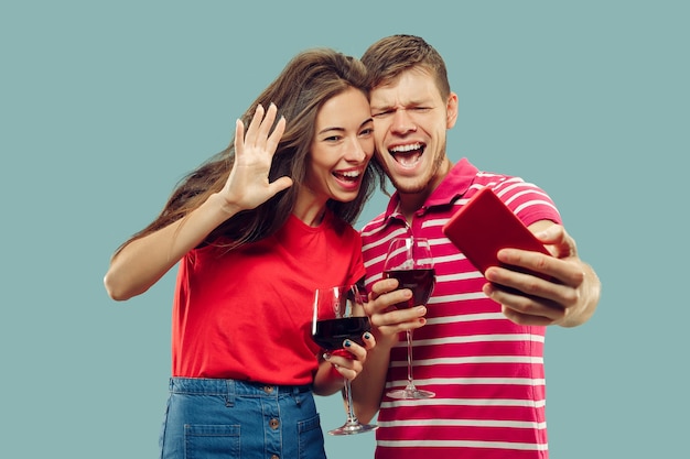 Beautiful Young Couple’s Half-Length Portrait Isolated on Blue – Free Download