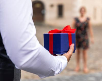 Wrapped Gift Held by Man – Free Stock Photo for Download