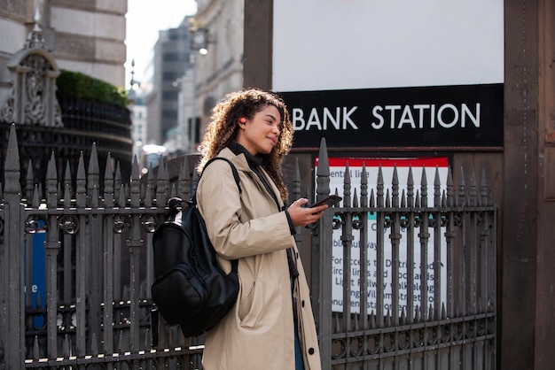 Young Woman Using Smartphone in the City – Free Download