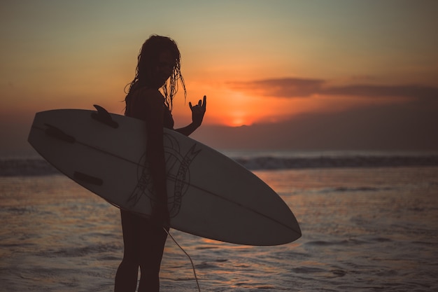 Girl Posing with a Board at Sunset – Free Stock Photo for Download