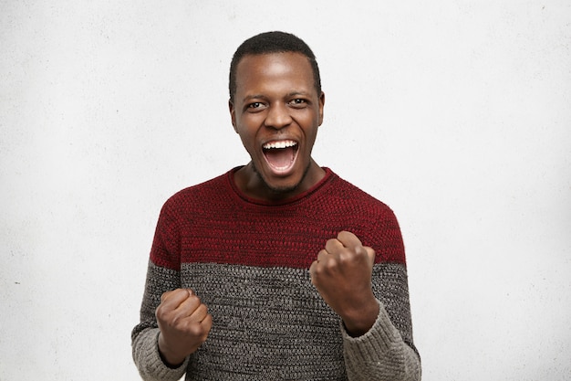 Young Dark-Skinned Male Winner Celebrating Success at Work – Free Download