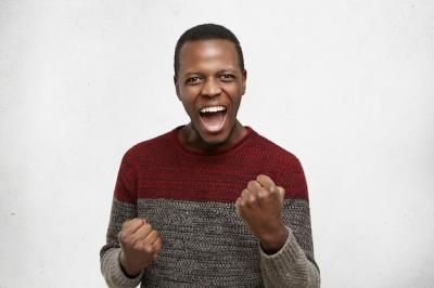 Young Dark-Skinned Male Winner Celebrating Success at Work – Free Download