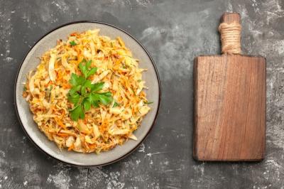 Close-Up View of Appetizing Cabbage with Carrots and Herbs on Wooden Board – Free Download