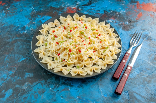 Raw Italian Farfalle Pasta with Vegetables on Blue Background – Free Stock Photo for Download