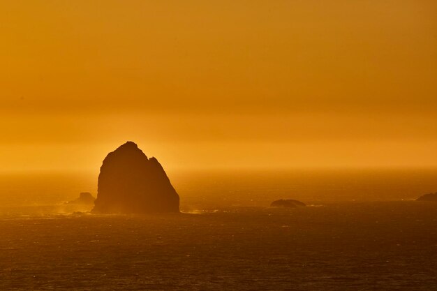 Golden Seascape with Silhouetted Island at Sunset – Free Stock Photo for Download