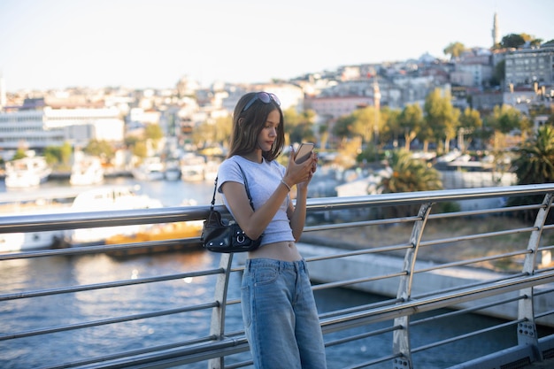 Teenage Girl Using Her Phone by the Bosphorus in Istanbul, Turkey – Free Stock Photo