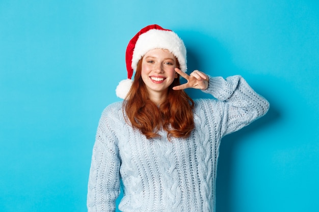 Happy Teenage Girl in Santa Hat Celebrating Winter Holidays | Free Stock Photo Download