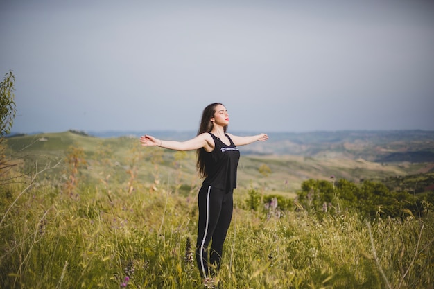 Woman in Grass with Hands Apart – Download Free Stock Photo