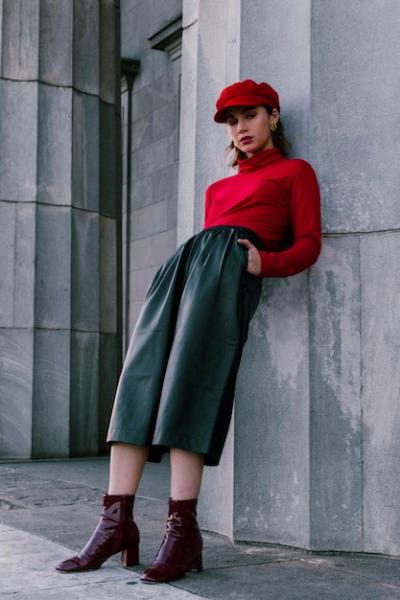 An Attractive Young Woman Leaning on a Wall with Hands in Her Pocket – Free Stock Photo for Download