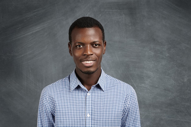 Confident Dark-Skinned Student in Checkered Shirt | Free Download