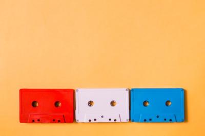 Red, White and Blue Cassette Tapes on Colorful Background – Free Download