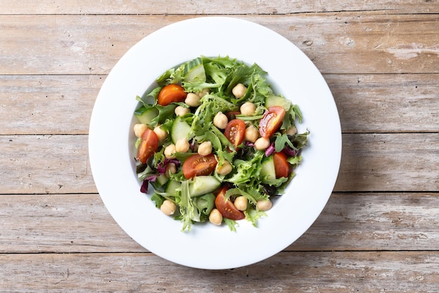 Chickpea Salad with Tomato, Lettuce, and Cucumber on Wooden Table – Free Download