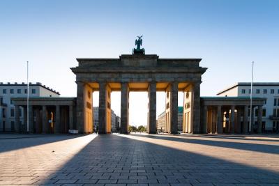 Stunning Sunset Over a Gate Against a Clear Blue Sky – Free Download