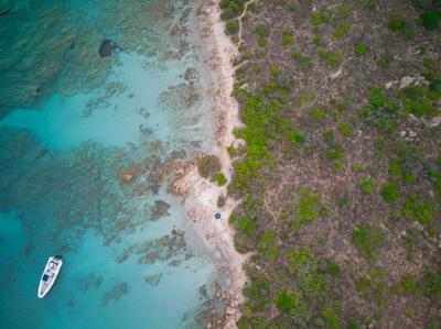 Stunning Top View of a Boat on Blue Sea Near the Seashore – Free Download