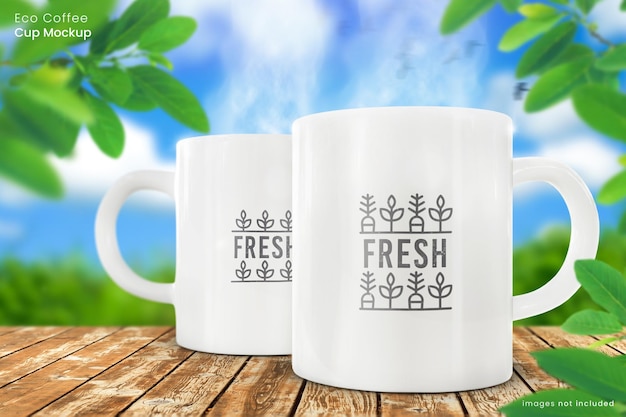 Two 11oz White Ceramic Mug Mockups on Wooden Table in Outdoor Nature Setting – Free Download