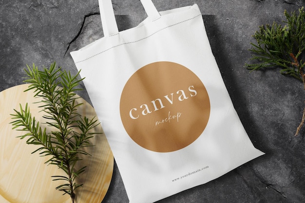 Clean Minimal Bag Canvas Mockup on Black Stone Texture with Conifer Background – Download Free Stock Photo