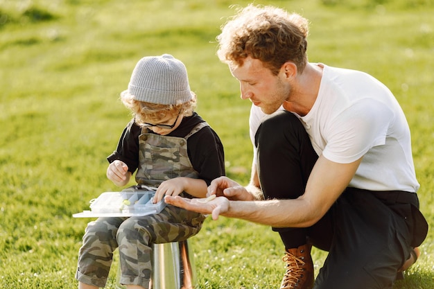 Outdoor Quality Time: Dad and His Curly Toddler Boy Enjoying Nature – Free Download